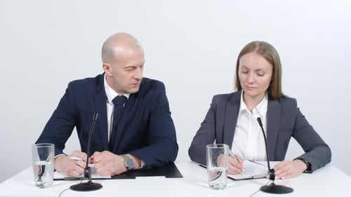 Business People Speaking at Corporate Press Conference