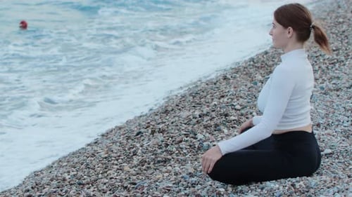 Sports Outdoors a Fitness Woman Doing Yoga By the Sea