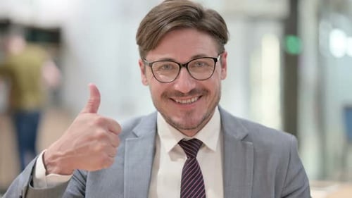 Man in Suit Gives Thumbs Up Approval