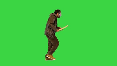 Scary Man From Nightmare or Horror Movie Walk Looking for Victim to Kill with Big Machete Knife on a