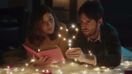 Romantic Couple Reads Book on Fairy Light Rug