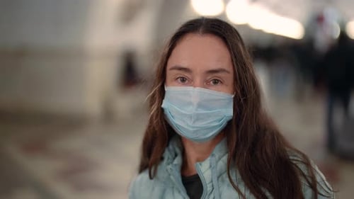 Woman Wearing Mask Looking at Camera Close Up