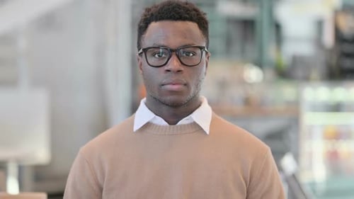 Confident Young Adult Portrait in Workplace