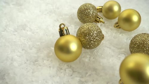 Falling Christmas toys on the snow. Decorative background. Slow motion.