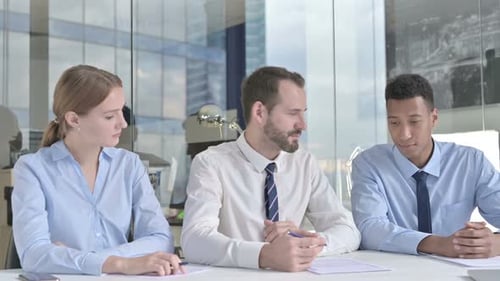 Three People Meet in Modern Office Conference Room