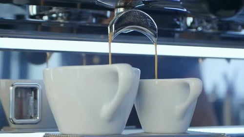 Espresso Machine Brewing Two White Mugs
