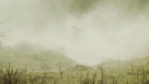 Motorcyclist Races on a Dusty Dirt Track
