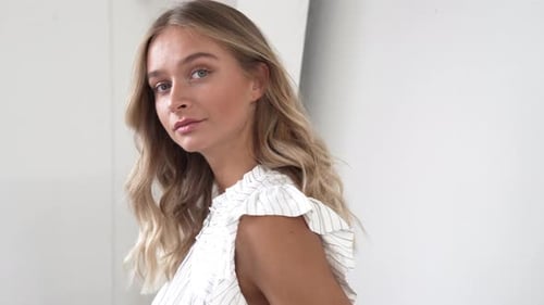 Blonde Woman Posing Gracefully in a White Room