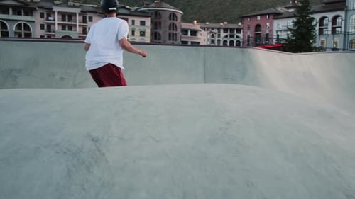 Skateboarder Riding Concrete Ramp in Skatepark