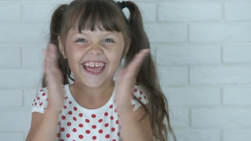 Happy Little Girl Smiling and Clapping Hands