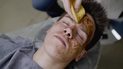 Man Receiving Coffee Facial Scrub Treatment
