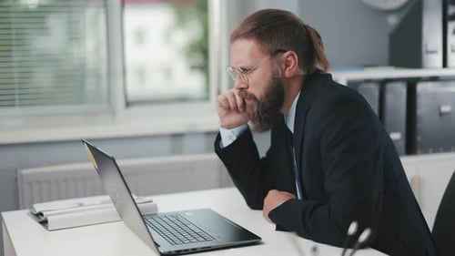 Businessman with Laptop at Office