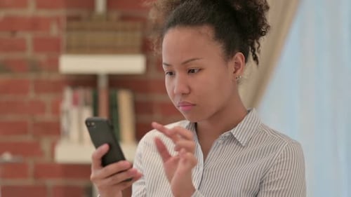 Young Woman Using Cellphone Indoors