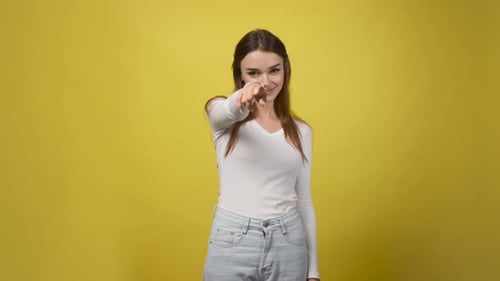 Smiling Woman Points And Makes Call Me Gesture