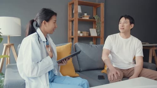 Doctor Consulting with Patient at Home