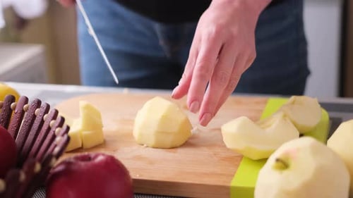 Cutting Fresh Apples on Wooden Cutting Board