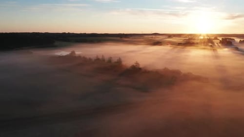 Aerial View of Rays of Sunshine Shining Above Foggy Horizon in Denmark