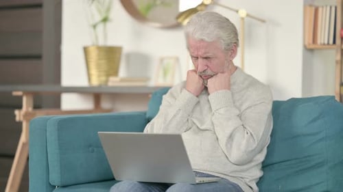 Senior Man Anxious While Using Laptop at Home