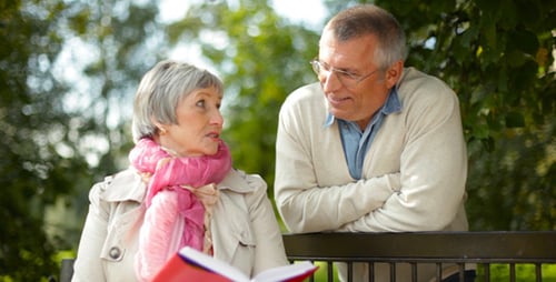 Senior Couple Reading in the Park Together