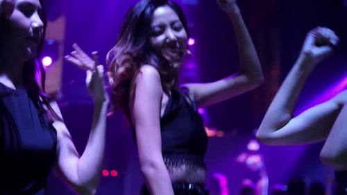 Young people are having fun dancing in club. Nightlife and disco concept.