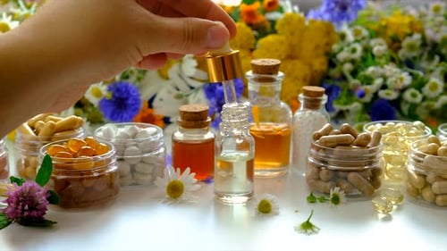 Natural Supplements with Medicine Dropper and Flowers