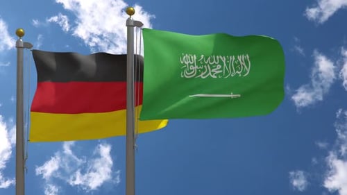 Germany and Saudi Arabia National Flags Waving Against Blue Sky