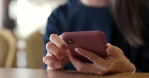 Woman use of mobile phone in restaurant