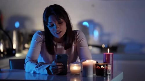 Woman Talking on the Phone by Candlelight