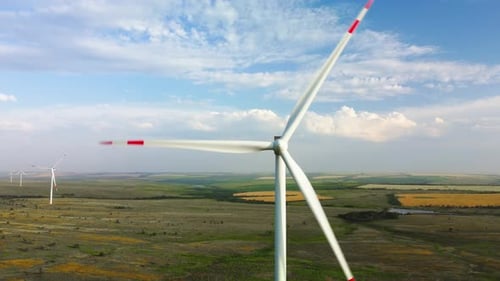 Wind Turbines in a Field Against the Sky
