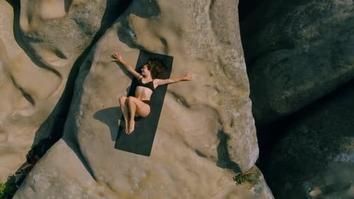 Woman Practicing Yoga Outdoors on Rocky Terrain