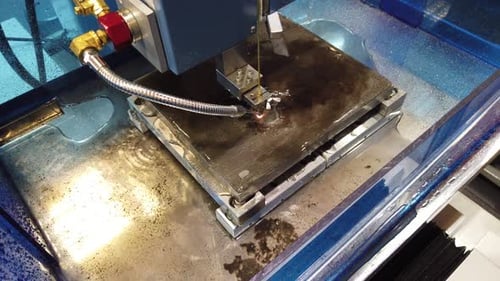 Electrical Discharge Machine Cuts Metal With Wire