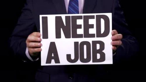 Man in Suit Holds "I Need A Job" Sign