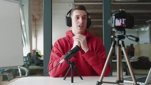 Happy Blogger Man Filming New Vlog Video with Professional Camera at Workplace at Office