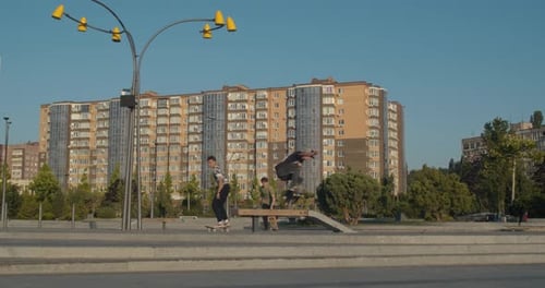 Three Skater Boys Are Doing Tricks and Jumping From the Stairs, Park,