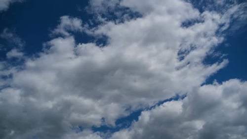 Clouds moving across a blue sky during daytime