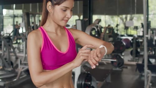Woman Using Smartwatch After Gym Workout