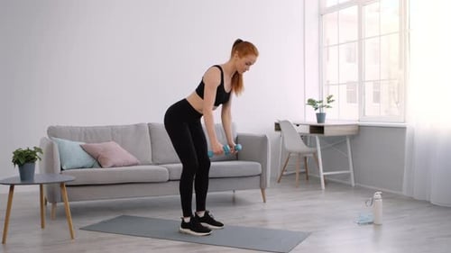Strong Lady Doing Forward Bend Dumbbells Exercise Training At Home