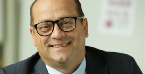 Smiling Man in Suit and Glasses Close-up
