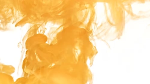 Abstract Yellowish-Orange Ink Flowing in Water