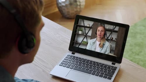 Overtheshoulder View Office Employee Talking Over Video Link While Sitting Desk