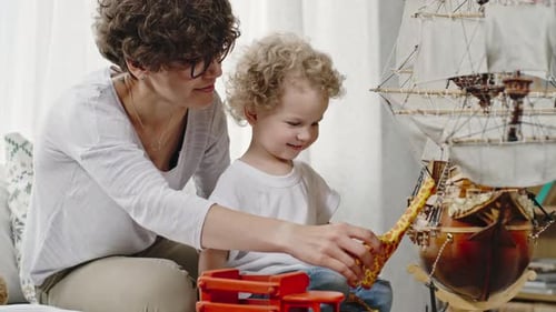Woman and Child Playing Together with Toys