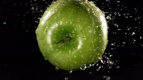 Flying of Green Apple in Black Background in Slow Motion