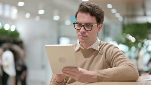 Young Male Designer Using Tablet in Office