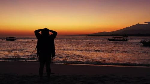 Young smiling lady travelling by the sea at the beach on paradise white sand and blue background 4K