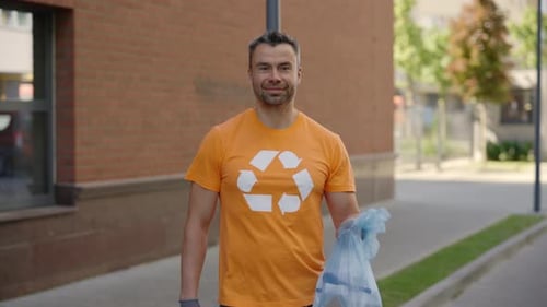Man Holding Recycling Bag on City Street