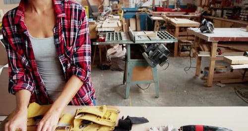Woman Setting up Tools in a Wood Shop