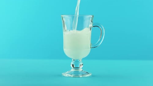 Yellow Lemon Fizzy Lemonade Soda Cold Beverage Drink Pooring Into Latte Glass Mug Blue