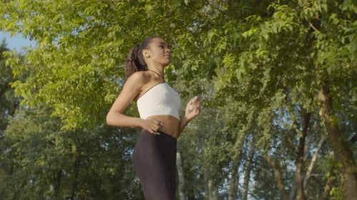 Female Jogger Running During Outdoor Workout in Park
