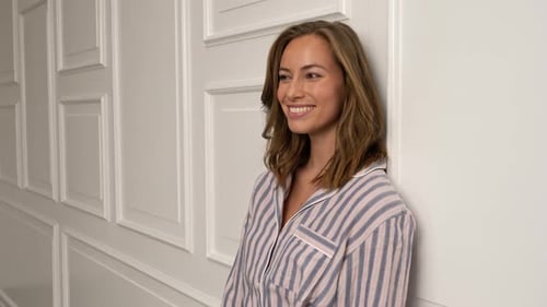 Woman in Pajamas Smiling Indoors