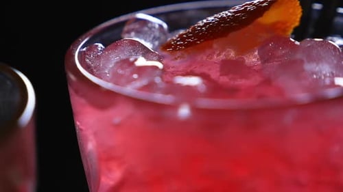 Short Clip of Cocktail Drinks with Ice and Club Lights Reflecting on the Glass
